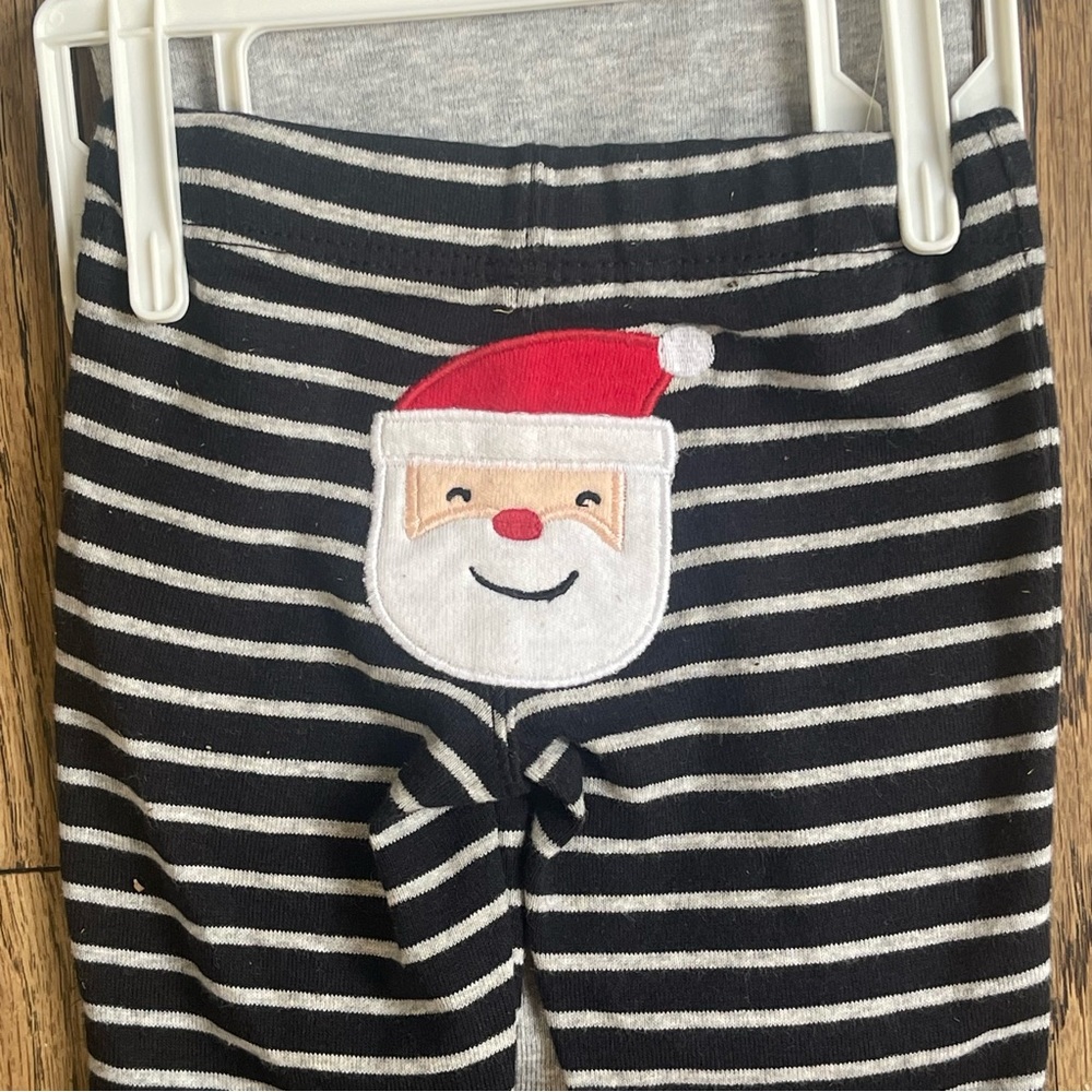 Carters two piece set. Santa’s little helper. New Born. New With Tags.
